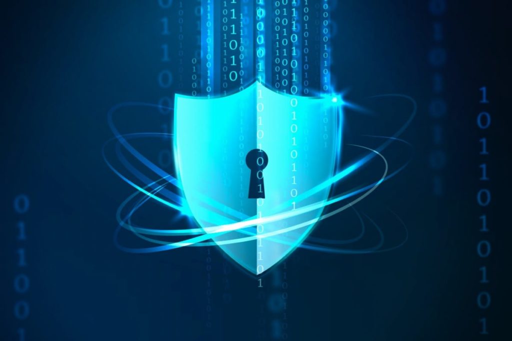 A shield with a keyhole surrounded by a force field depicting protection of all the data that represented in 1's and 0's. The intended use is to provide a context of cybersecurity